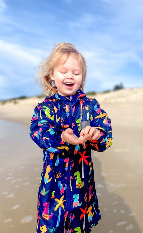 Beach swim parka worn by toddler on the beach. Swim parka is water resistant and keeps children warm after swimming. 