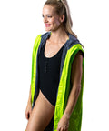 Lady wearing fluro green swim parka, Swim Parka has arms removed and lady is wearing swimmers. 